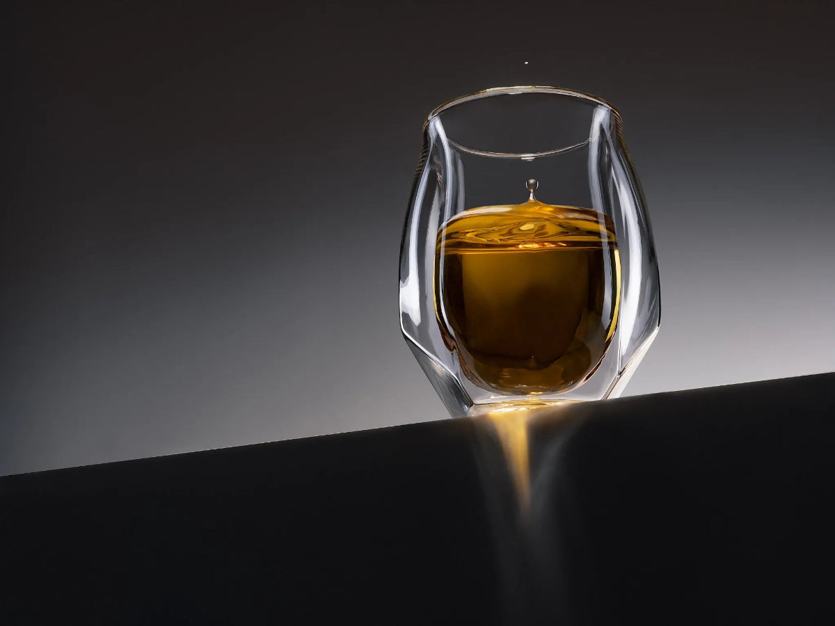 Norlan Whisky Glass showcasing golden whisky with a mid-air droplet