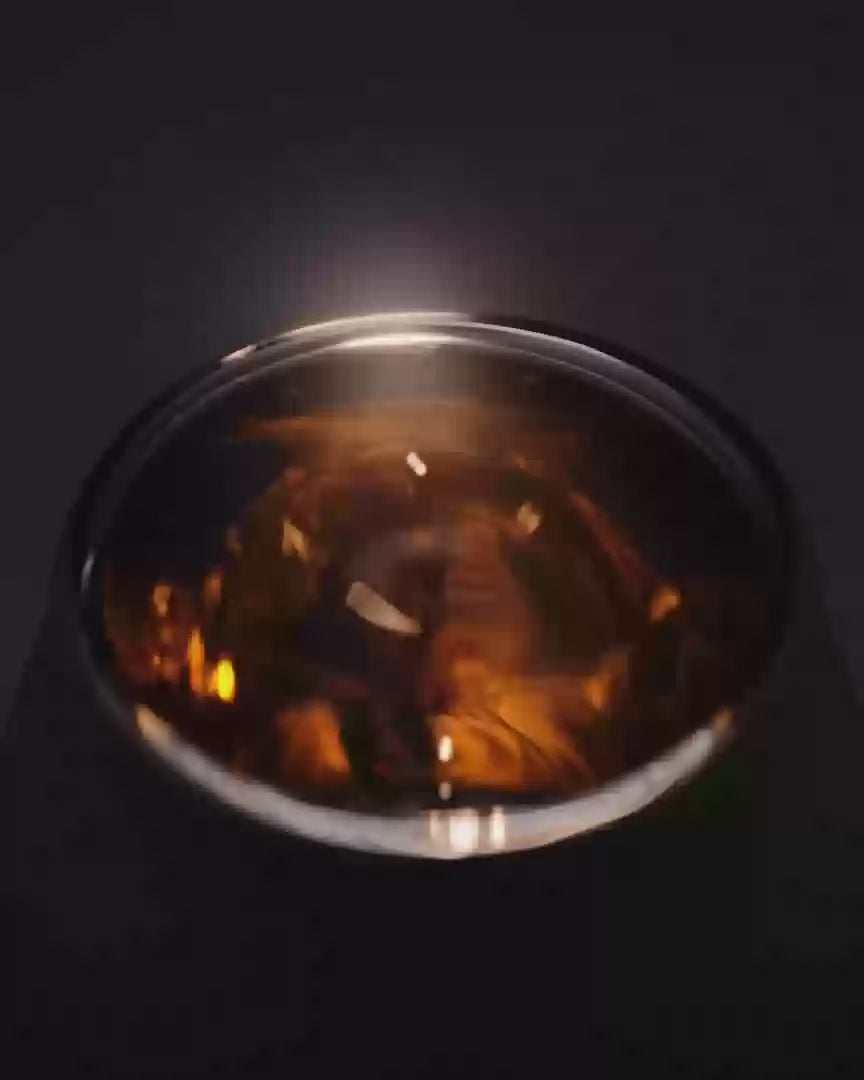 Close-up of the shadowed nosing capsule in the VAILD glass, partially obscured to emphasize form and contrast.